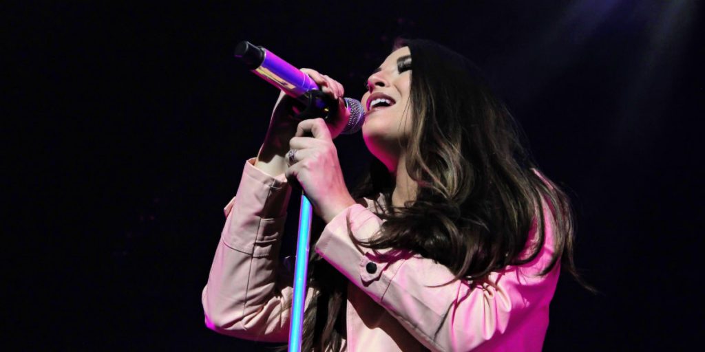 Jess Moskaluke singing on stage at Rogers Place in Edmonton