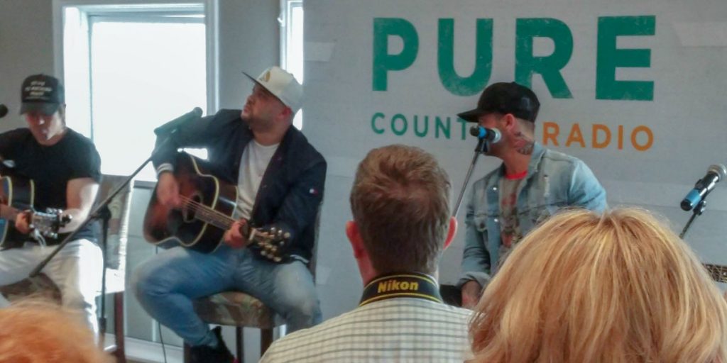 Tebey and Dallas Smith performing acoustic songs at the Tebey Golf Classic