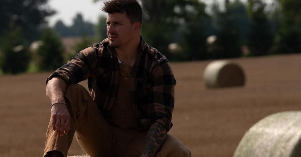 Ryan Connolly sitting on a hay bail