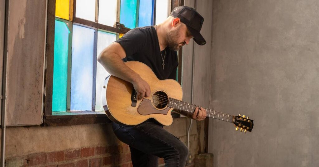 Aaron Goodvin playing the guitar