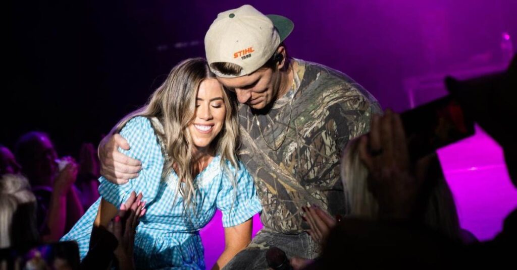 Jenna and Stu Walker hug on stage at the launch of their new foundation