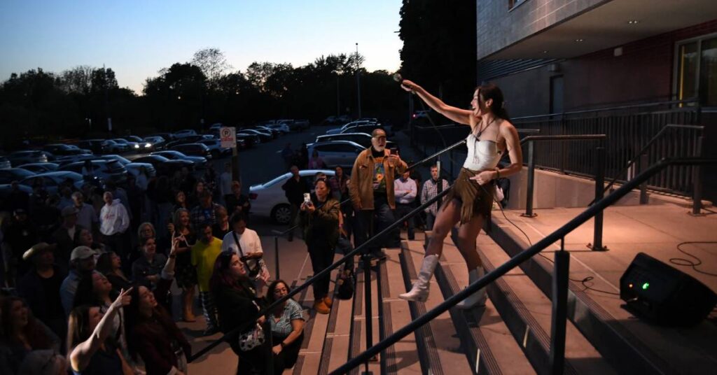 Jade Hilton performing in a parking lot